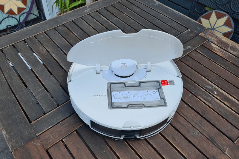 The Roborock S7 Pro Ultra vacuum robot stands on the table with an open flap.